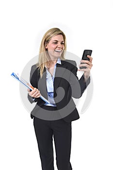 Young beautiful blond hair businesswoman using internet app on mobile phone holding office folder and pen smiling happy