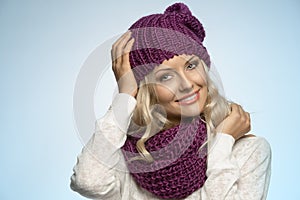 Young beautiful blond wearing scarf and winter hat