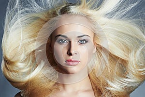 Young beautiful blond woman with long hair. pretty girl. Beauty salon haircare