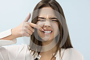 Young beautiful blond woman standing on isolated white background suffering from sudden gum pain, touching her tooth, healthcare