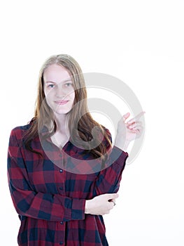 Young beautiful blonde casual caucasian woman pointing to copy space isolated on white background