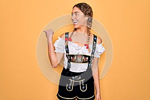 Young beautiful blonde german woman with blue eyes wearing traditional octoberfest dress smiling with happy face looking and