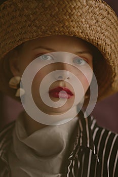 Young beautiful blonde girl in a straw hat