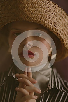 Young beautiful blonde girl in a straw hat