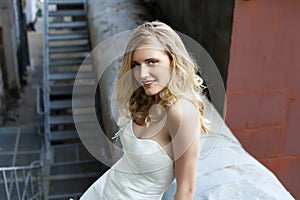 Young beautiful blonde woman in bridal dress