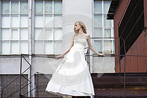 Young beautiful blonde woman in bridal dress