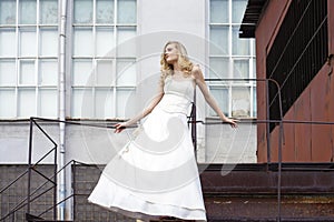 Young beautiful blonde woman in bridal dress