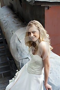 Young beautiful blonde woman in bridal dress