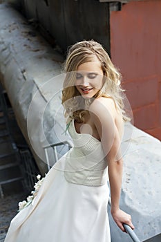 Young beautiful blonde woman in bridal dress