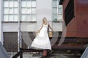 Young beautiful blonde woman in bridal dress