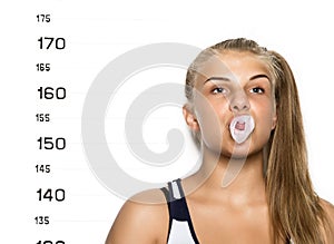 Young beautiful blonde woman chewing gum and blowing bubbles Criminal Mug Shots