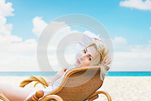 Young beautiful blonde woman enjoying tropical sea view