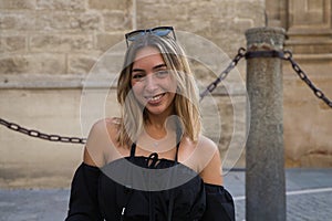 Young and beautiful blonde woman making different gestures and expressions with her face while looking at the camera on her