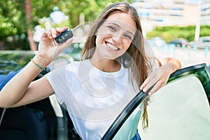 Young beautiful blonde woman smiling happy driving car