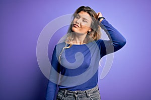 Young beautiful blonde woman wearing casual t-shirt over isolated purple background confuse and wondering about question