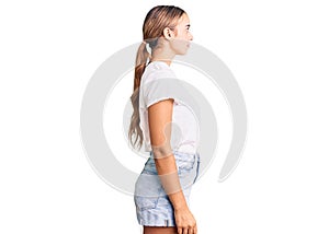 Young beautiful blonde woman wearing casual white tshirt looking to side, relax profile pose with natural face with confident