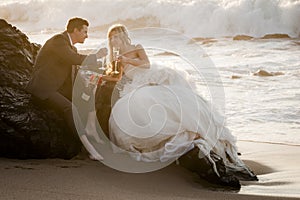 Young beautiful bridal couple having fun together at the beach