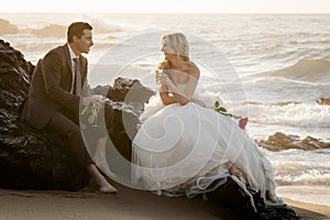 Young beautiful bridal couple having fun together at the beach