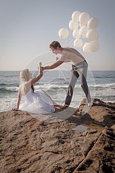 Young beautiful bridal couple having fun together at the beach