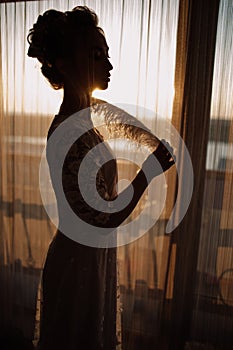 Young beautiful bride in boho style and white feathers