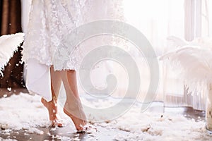 Young beautiful bride in boho style and white feathers