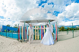 Young and beautiful bride and groom on the beach