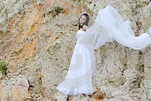 Young beautiful bride among sands thoughtful