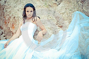 Young beautiful bride among sands thoughtful