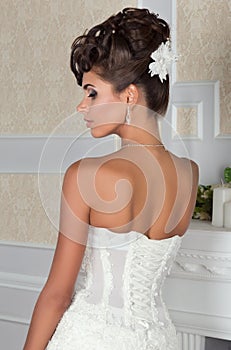 Young beautiful bride standing back to camera