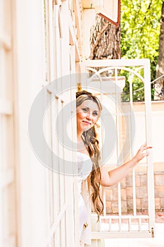 Young beautiful bride waits for groom near the window. Beautiful Bride lit by sunlight. beautiful young bride waiting