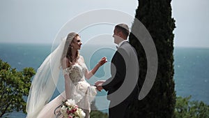 Young beautiful bride in a wedding dress and groom hugging and kissing