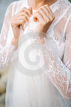 Young beautiful bride in wedding dress near sea