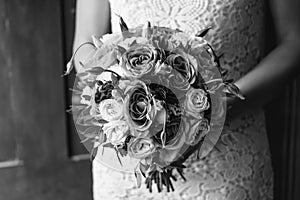 Young beautiful bride in white dress holding wedding bouquet, bouquet of bride from rose cream spray, rose bush, rose purple