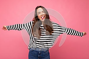 Young beautiful brunet woman. Trendy lady in casual striped longsleeve. Positive female shows facial sincere emotions