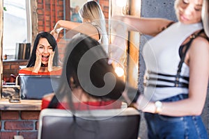 Young beautiful brunette at a reception at the hairdresser. Hair cut, hairstyle, Spa treatment, care.