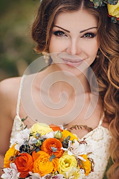 Young beautiful brunette woman in blooming garden