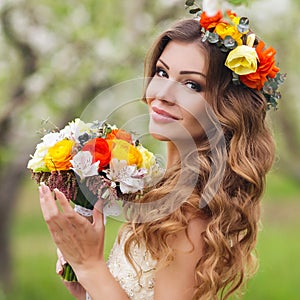 Young beautiful brunette woman in blooming garden