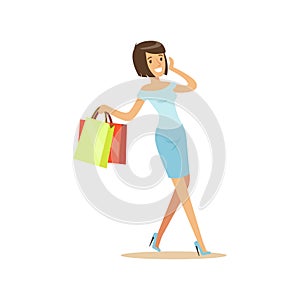 Young beautiful brunette woman in an elegant clothes walking with shopping bags and talking on mobile phone colorful