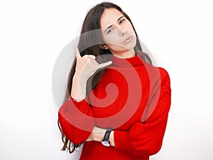 Young beautiful brunette woman in red sweater thinking looking to the side at blank copy space, isolated over white background