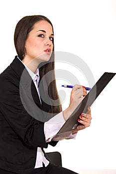 Young beautiful brunette holding scheduler and writing