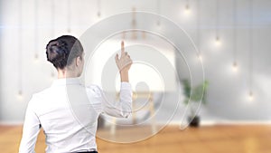 Young beautiful business woman and creative designer standing over blured interior background