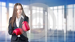 Young beautiful business woman and creative designer standing over blured interior background