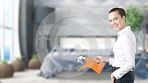 Young beautiful business woman and creative designer standing over blured interior background