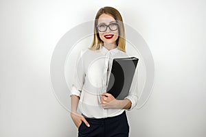 Young beautiful business woman in eyeglasses holding black folder with documents isolated white background