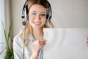 Young beautiful business woman with headphones working from home having online meeting