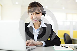 Young beautiful business woman with headset