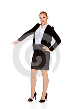 Young beautiful business woman pointing down