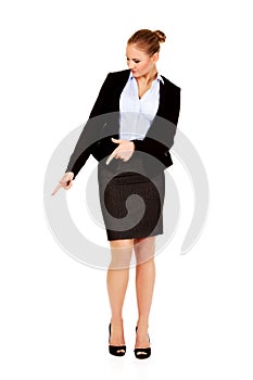 Young beautiful business woman pointing down