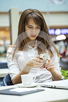 Young beautiful business woman reading messages