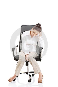 Young beautiful business woman sitting on a chair.